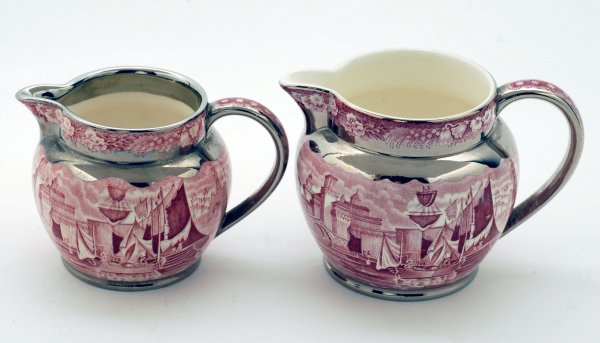 Appraisal: Two Wedgwood Ferrara pitchers with silver luster trim marked under