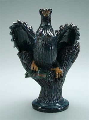 Appraisal: Rex Hogan stoneware eagle perched on tree and holding fish