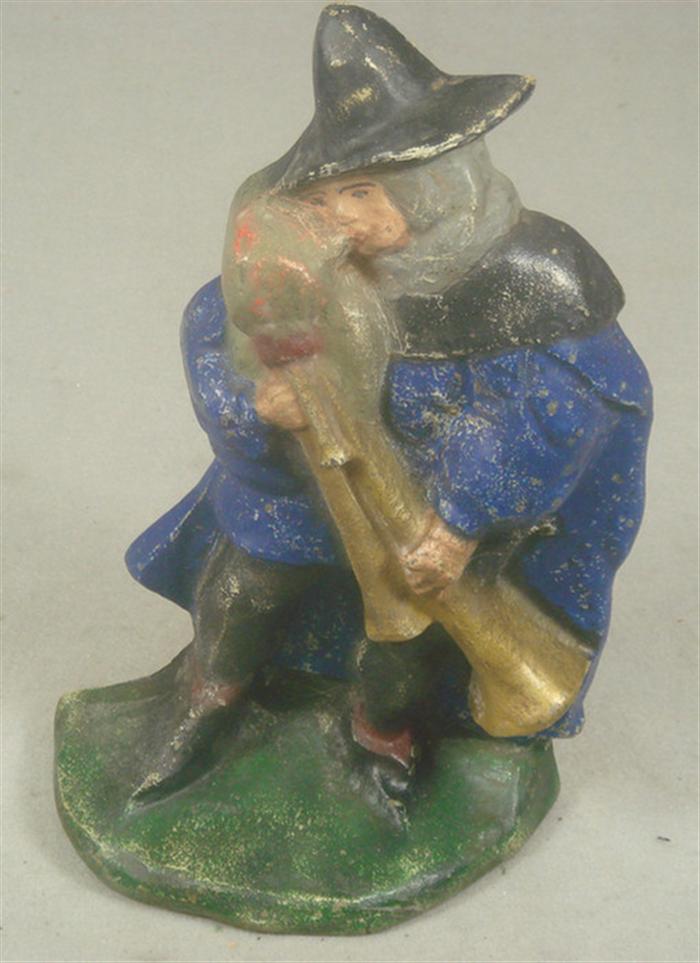 Appraisal: Cast iron doorstop man playing bagpipe instrument standing on green