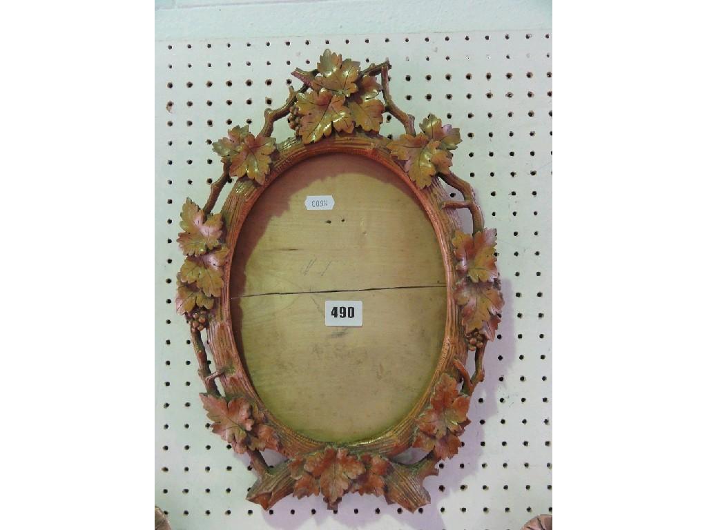 Appraisal: An oval picture frame with carved grape and vine leaf