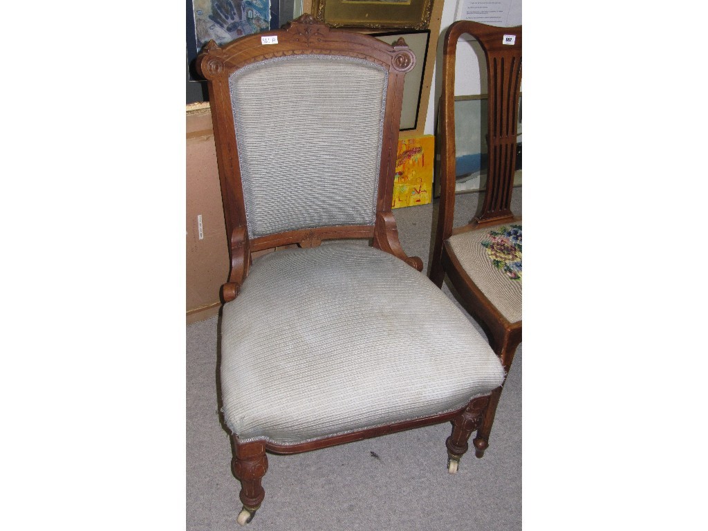 Appraisal: Victorian walnut and fabric covered nursing chair raised on ceramic