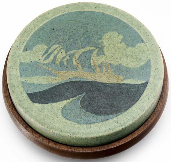 Appraisal: MARBLEHEAD Circular trivet tile decorated in wax-resist with a tall