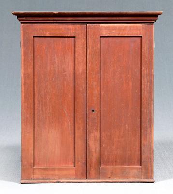 Appraisal: Red painted cherry hanging cupboard original surface with two paneled