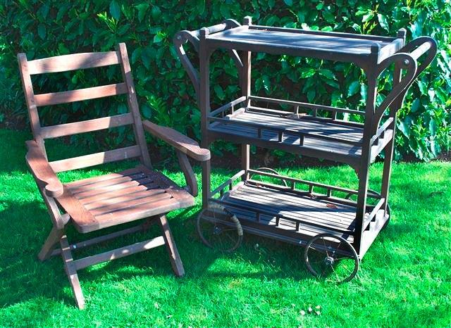 Appraisal: A teak three tier garden trolley with turned handles to