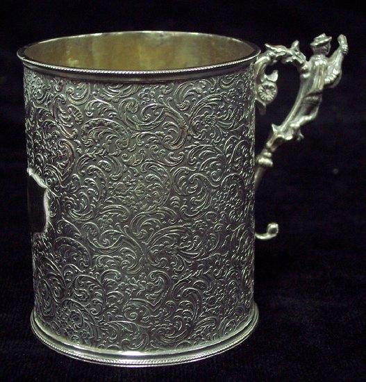 Appraisal: A Christening mug decorated floral scrolls in low relief the