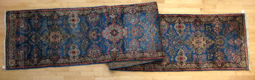 Appraisal: Kirman runner ca with floral design on a blue field