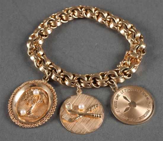 Appraisal: K gold bracelet bearing three charms inches length grams Estimate