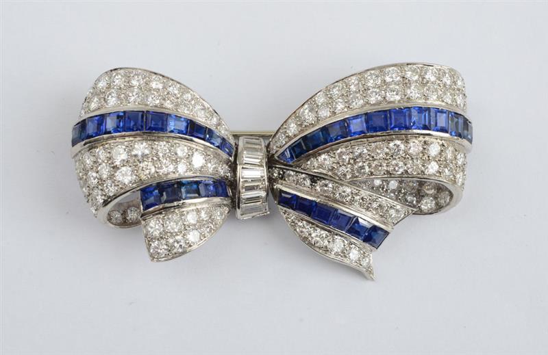 Appraisal: PLATINUM DIAMOND AND SAPPHIRE BOW BROOCH The three dimensional bow