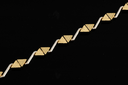 Appraisal: A modern two tone gold bracelet Designed as a series