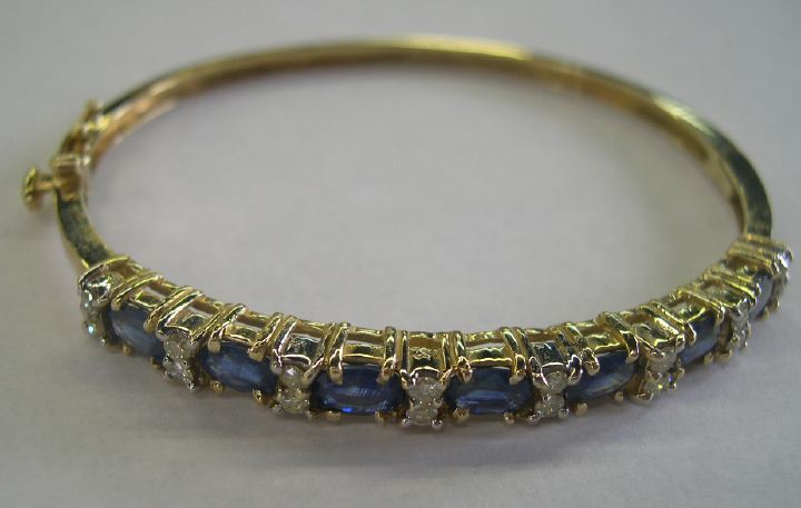 Appraisal: Fourteen-Karat Yellow Gold Sapphire and Diamond Bangle Bracelet featuring seven