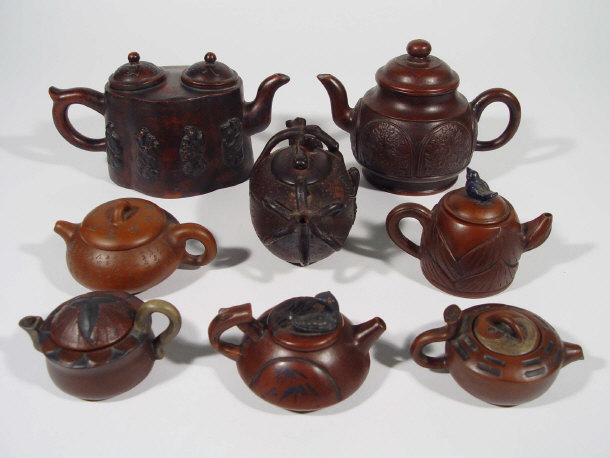 Appraisal: Eight Chinese Yixing stoneware teapots and covers with relief moulded