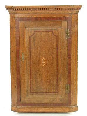 Appraisal: An early th century oak hanging corner cupboard with mahogany