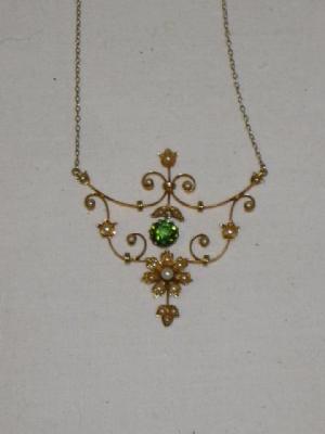 Appraisal: AN EDWARDIAN PERIDOT AND SEED PEARL NECKLACE the scroll work