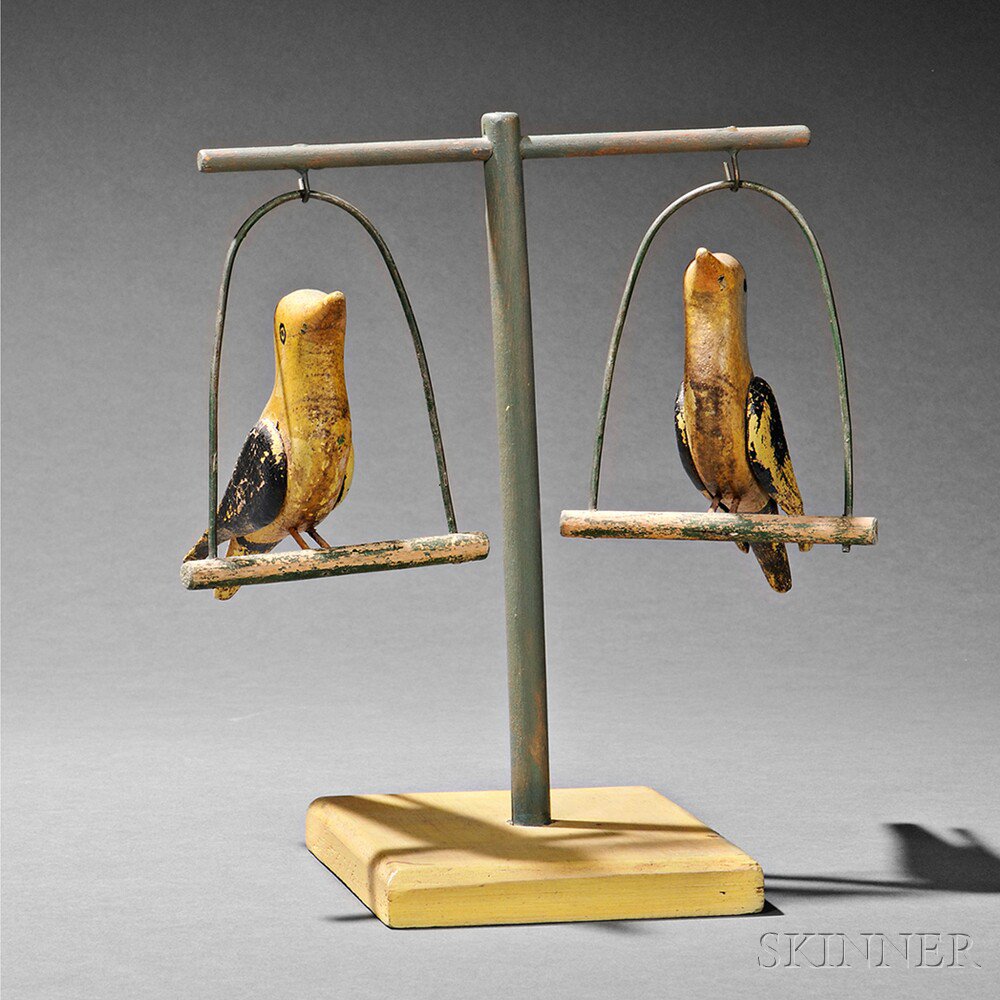 Appraisal: Pair of Yellow-painted Perched Bird Figures America early th century