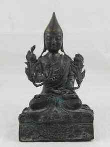 Appraisal: A bronze Hindu deity in the lotus position with relief