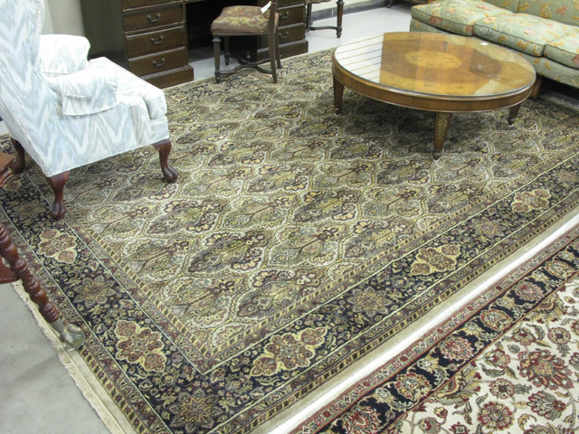 Appraisal: HAND KNOTTED ORIENTAL CARPET Indo-Persian overall repeating fleur-de-lis motif '