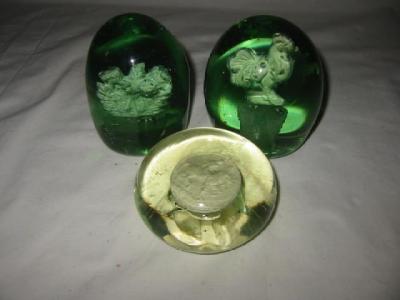 Appraisal: A PAIR OF GREEN GLASS DUMPS of tapering form each