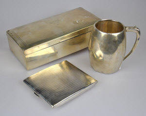 Appraisal: A silver barrel-shaped Christening mug a heavy quality cigarette case