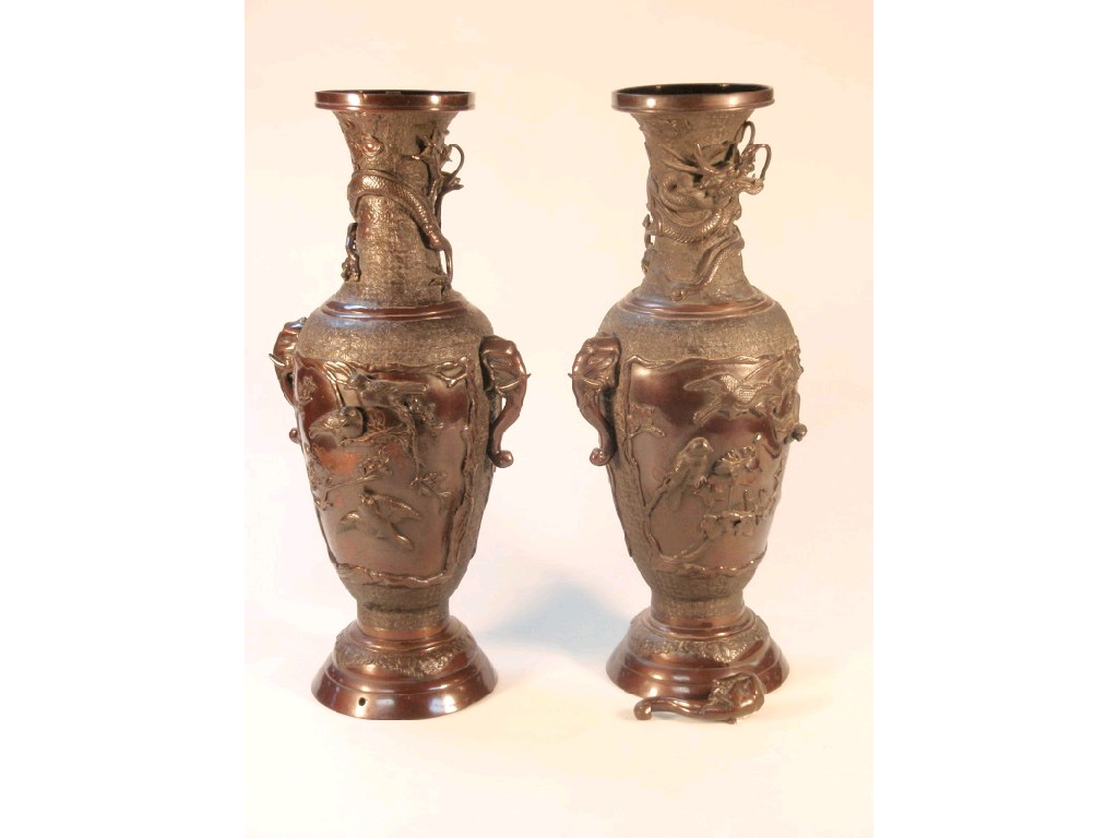 Appraisal: A pair of Japanese cast bronze vases with elephant mask