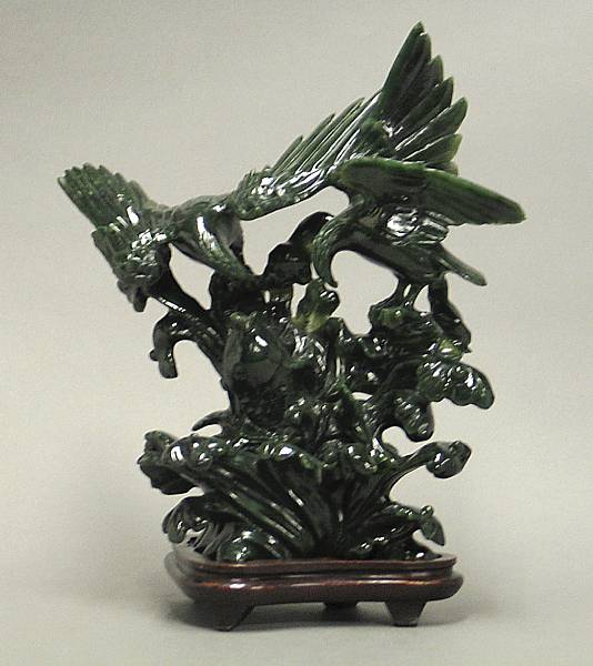 Appraisal: A green hardstone carving Depicting an eagle group watching a