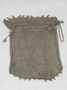 Appraisal: A heavy silver mesh purse with interwoven draw chain apparently