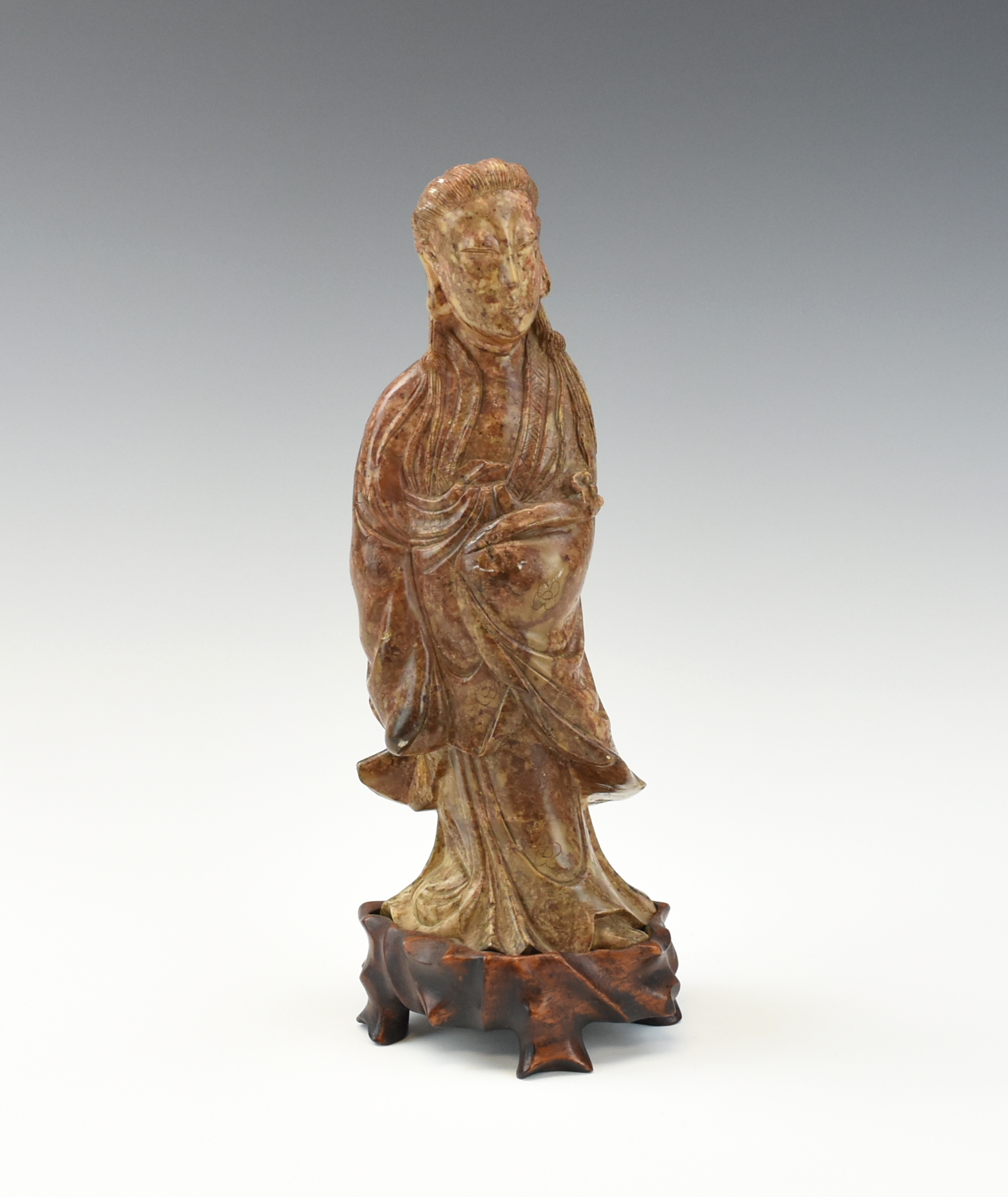 Appraisal: CHINESE SOAPSTONE CARVING OF GUANYIN the standing figure of Guanyin