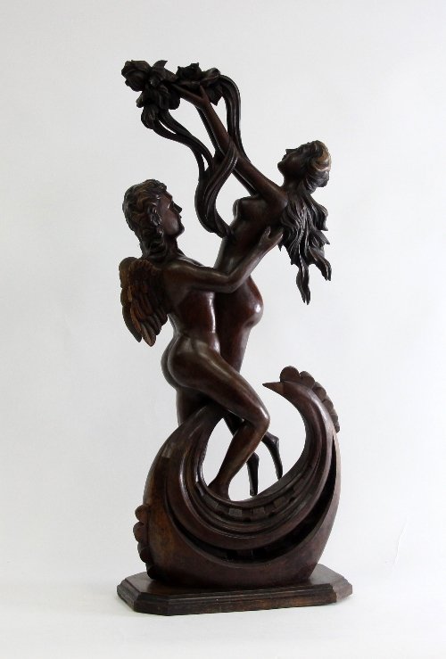 Appraisal: A carved wood figure angel and girl holding flowers aloft