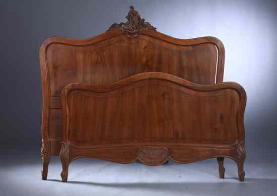 Appraisal: TWO LOUIS XV STYLE WALNUT DOUBLE-SIZE BED-FRAMES Carved arched crest