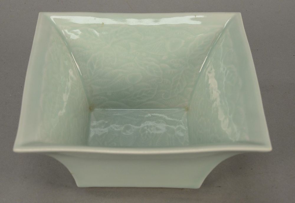 Appraisal: Celadon glazed square bowl interior with incised fish design height