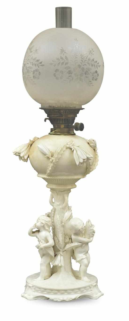 Appraisal: A MOORE BROTHERS PORCELAIN KEROSENE LAMP Circular base with three