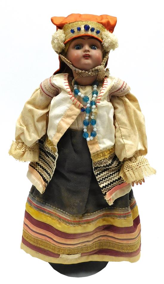 Appraisal: DOLL Ethnic Russian bisque doll in traditional dress blonde braid