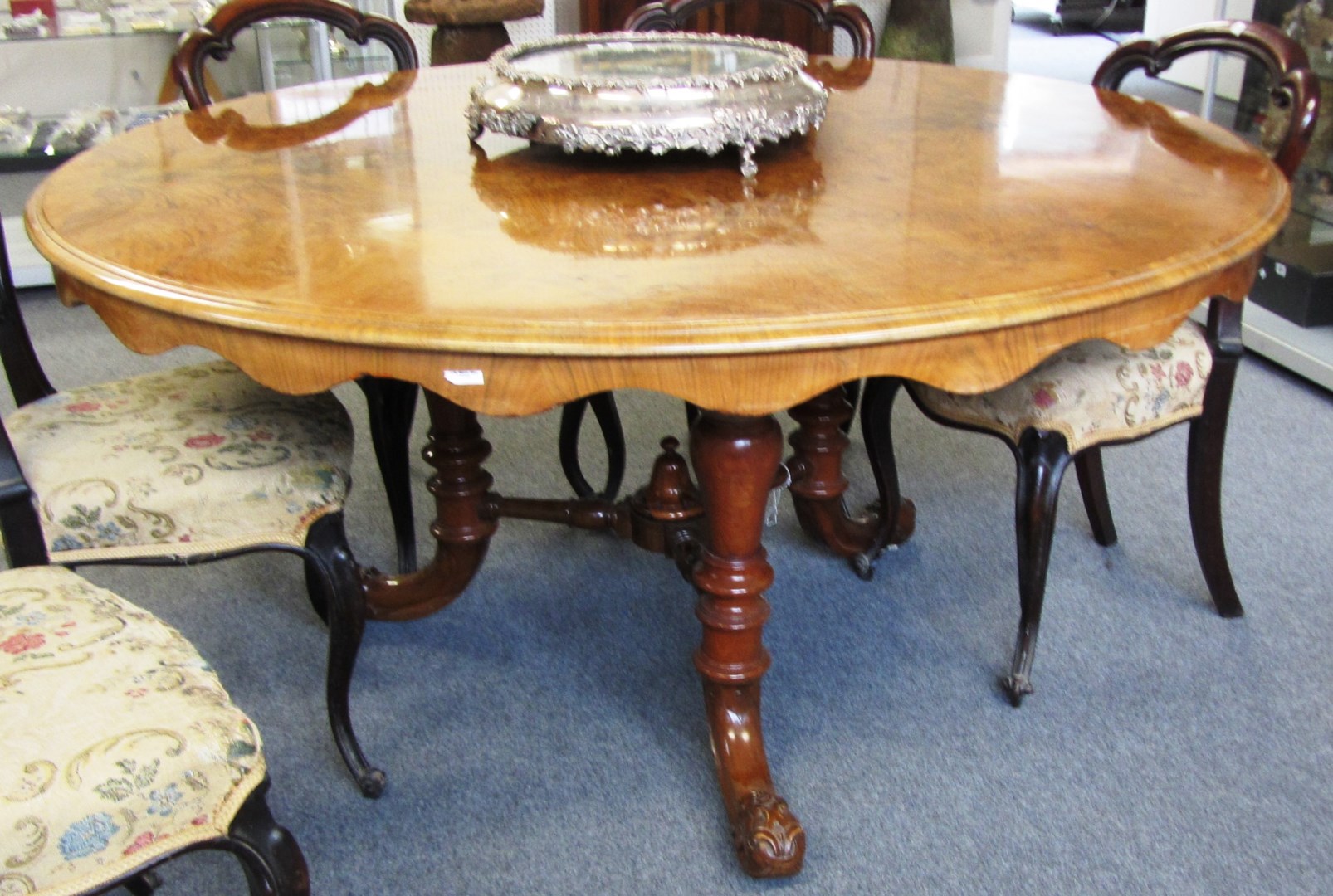 Appraisal: A Victorian figured walnut circular centre table on three turned