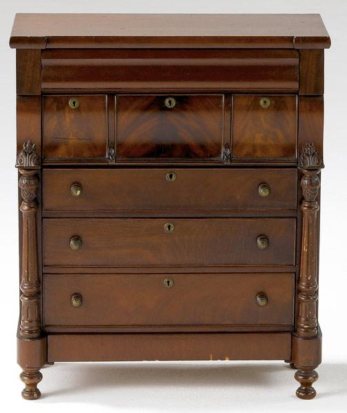 Appraisal: MINIATURE EMPIRE CHEST OF DRAWERS Seven drawers with corner columns