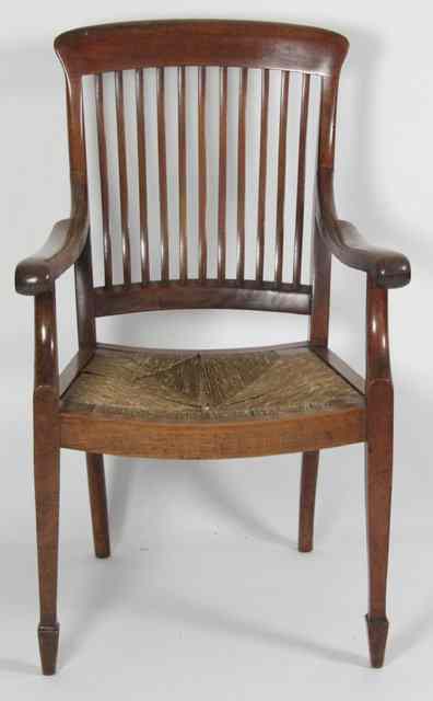 Appraisal: An Edwardian armchair with rush seat on square tapering legs