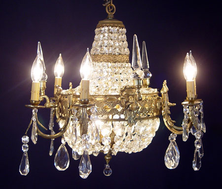 Appraisal: FRENCH BRONZE CRYSTAL CHANDELIER Masquerons and crystal prisms The chandelier