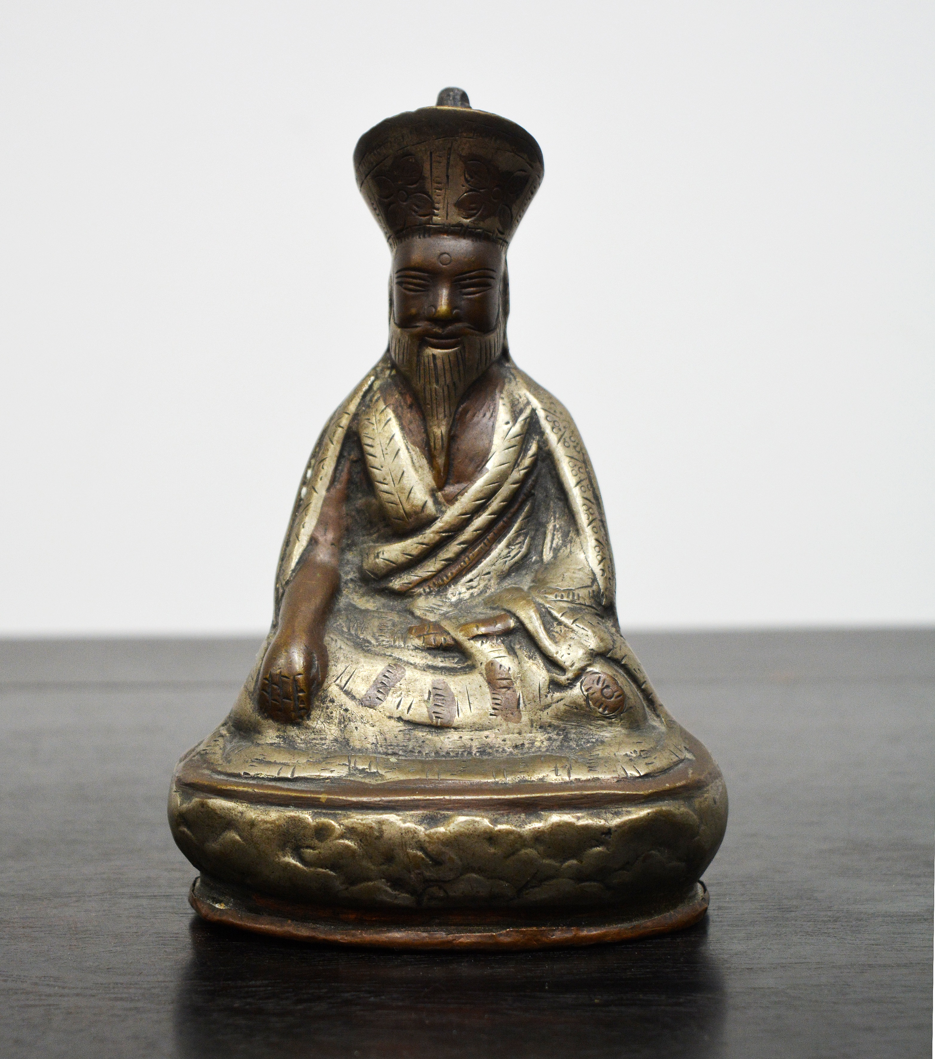 Appraisal: Small copper and white metal buddhaSino-Tibetan the figure wearing traditional