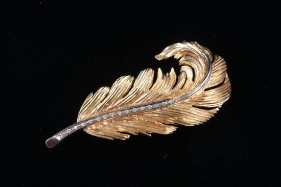 Appraisal: K YELLOW AND WHITE GOLD AND DIAMOND FEATHER-FORM PIN Row