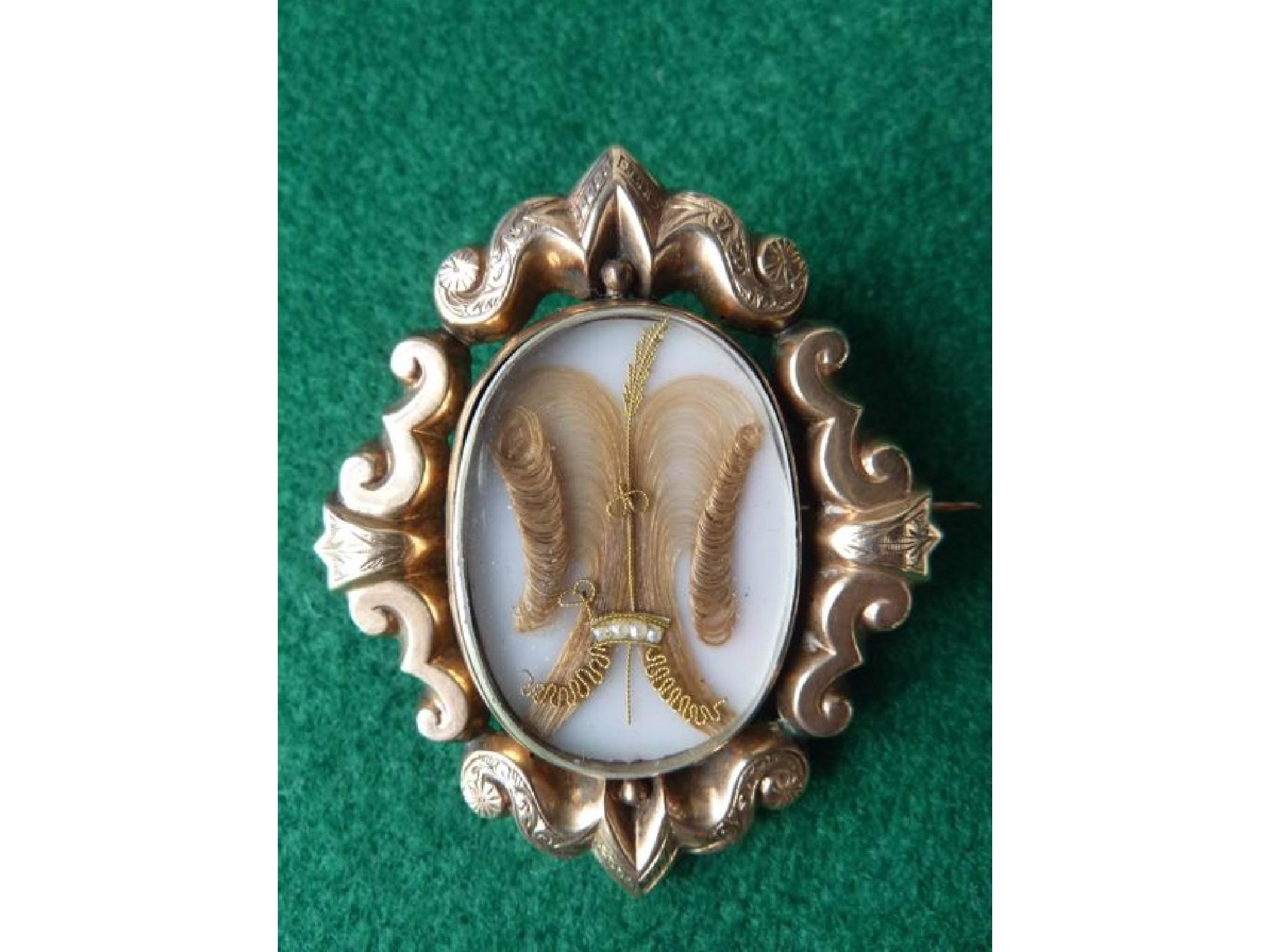 Appraisal: A th century memorial brooch with gilded scrolled frame enclosing