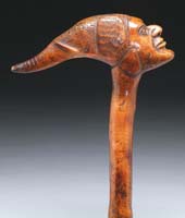 Appraisal: CARVED WOOD HANDLED ELEPHANT AND FACE CANE The handle having