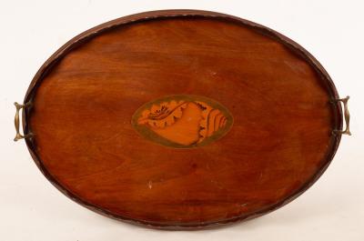 Appraisal: An Edwardian oval mahogany tray with wavy rim and central