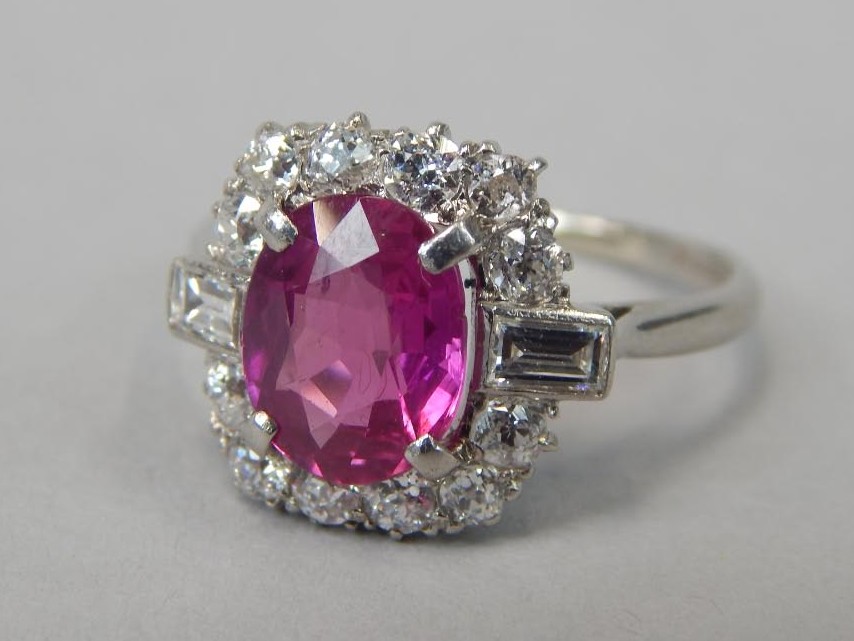 Appraisal: A ruby and diamond set dress ring the central stone