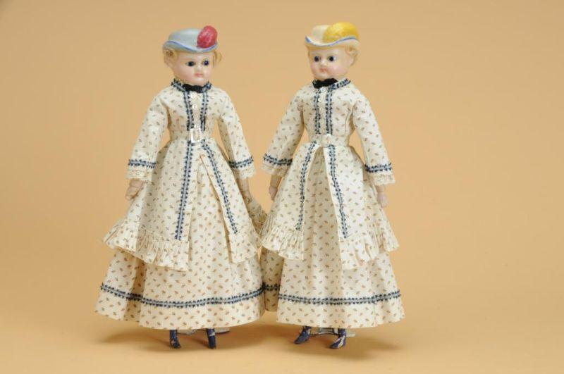 Appraisal: Wax Sister Dolls with Molded Bonnets Germany ca a matching