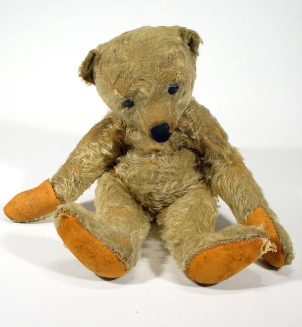 Appraisal: Edwardian straw filled jointed golden teddy bear cm high