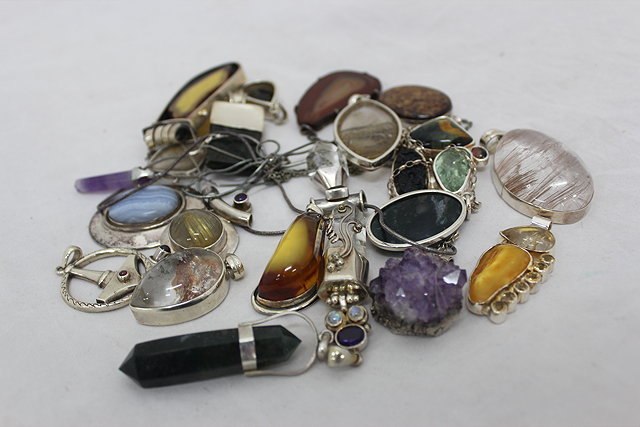 Appraisal: A COLLECTION OF ROCK CRYSTAL HARD STONE SET SILVER PENDANTS