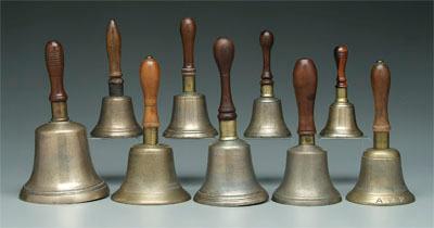 Appraisal: Collection of nine brass school bells all with turned wooden