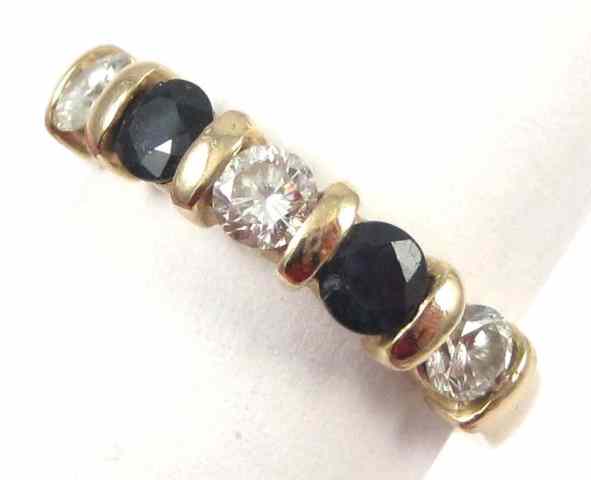 Appraisal: SAPPHIRE DIAMOND AND FOURTEEN KARAT GOLD RING set with three