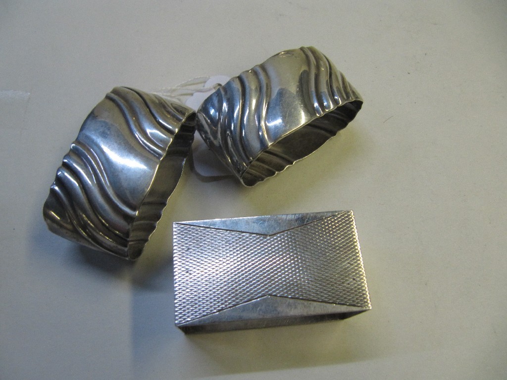 Appraisal: Lot comprising pair of silver napkin rings and a single