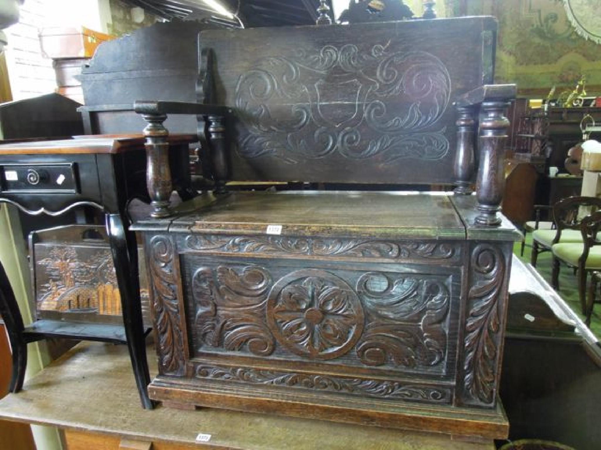 Appraisal: A late Victorian carved oak monks' bench with box seat