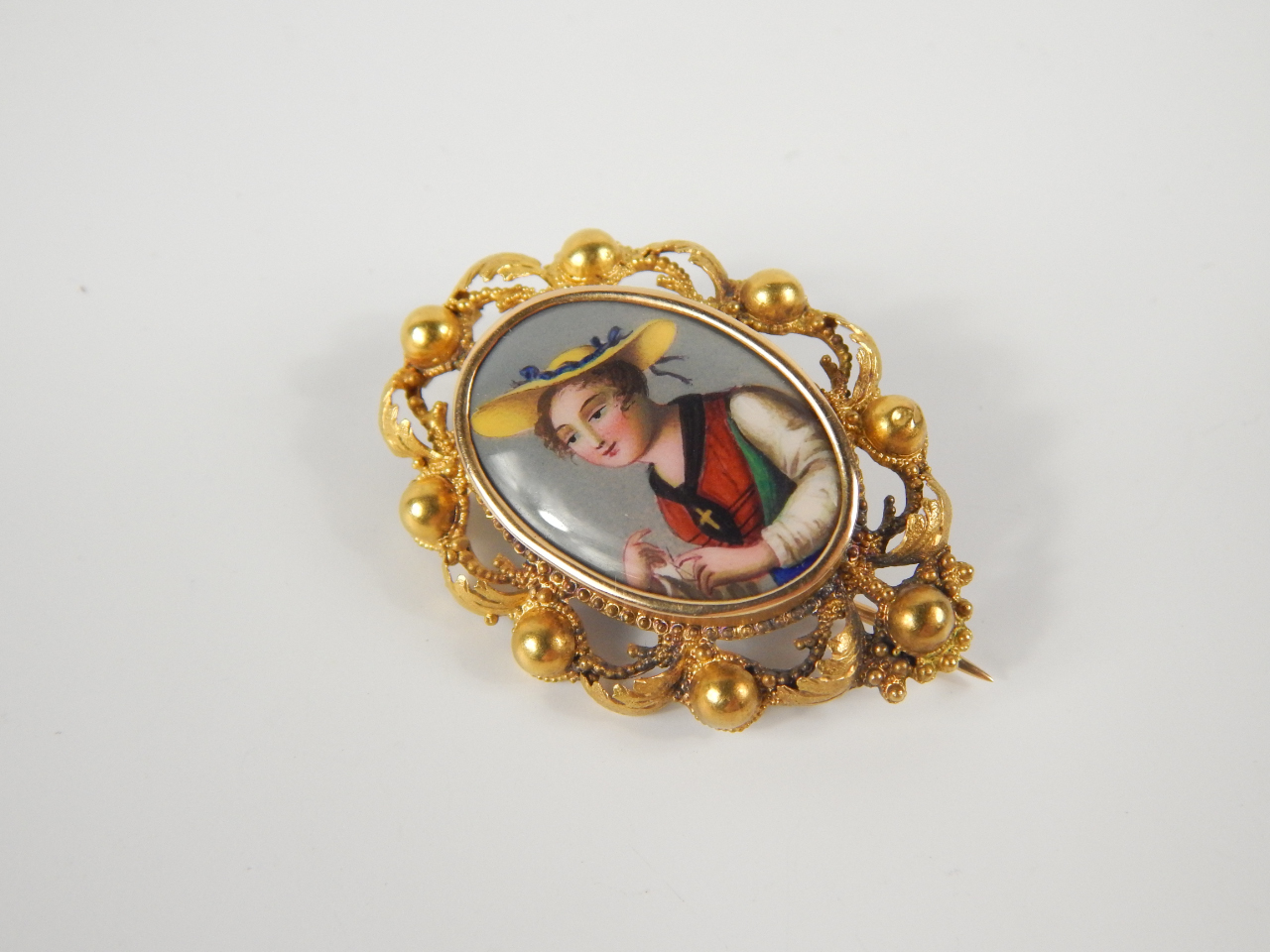 Appraisal: A thC oval painted enamel portrait brooch of a Swiss