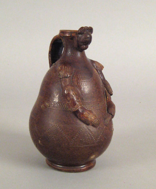 Appraisal: Redware figural pitcher th c baluster form with a face